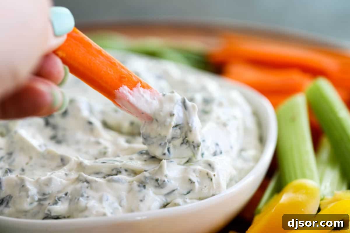 Texture of creamy spinach dip in a bowl with a spoon