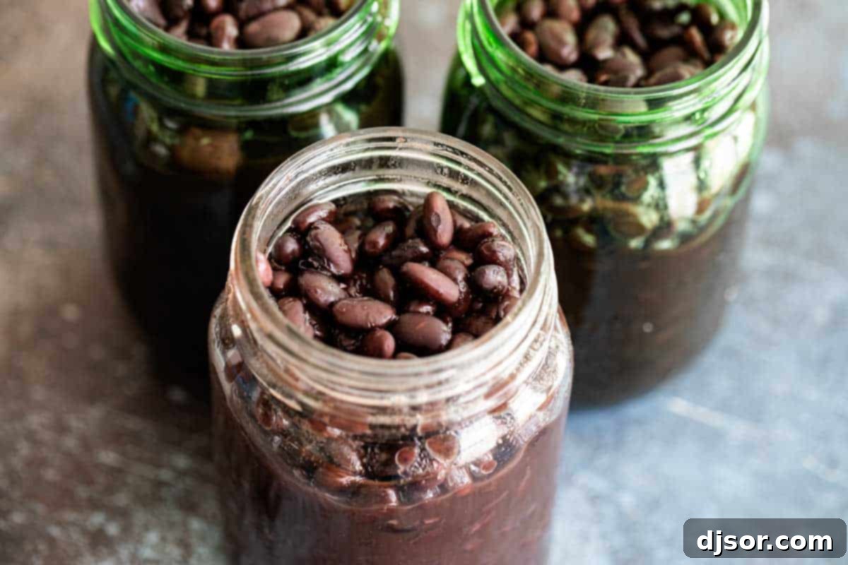 Slow Cooked Black Beans 2 Soft Slow Cooker Black Beans in glass jars for easy storage.