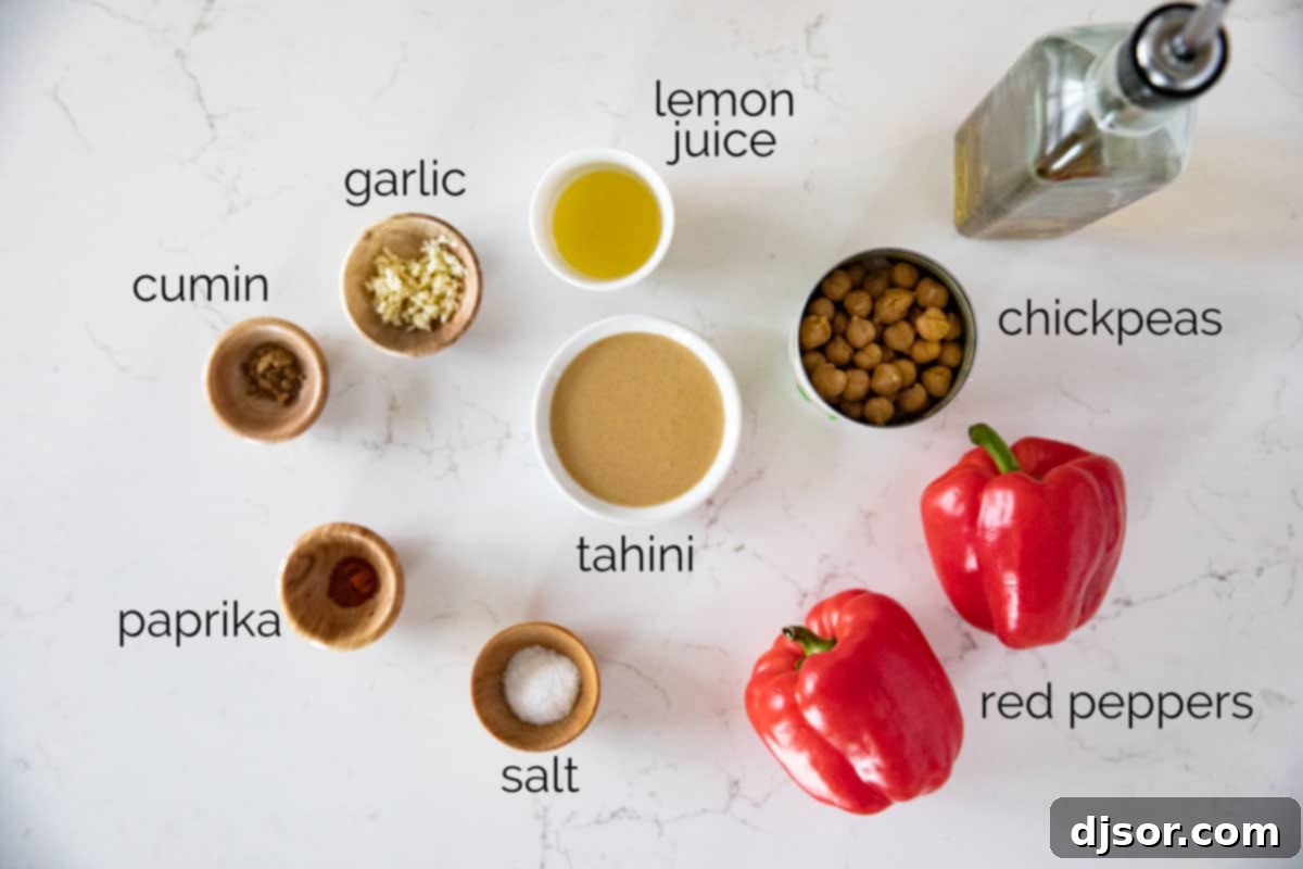 A vibrant display of fresh ingredients for homemade roasted red pepper hummus. Fresh red bell peppers, chickpeas, tahini, lemon, garlic, and spices laid out for making roasted red pepper hummus.