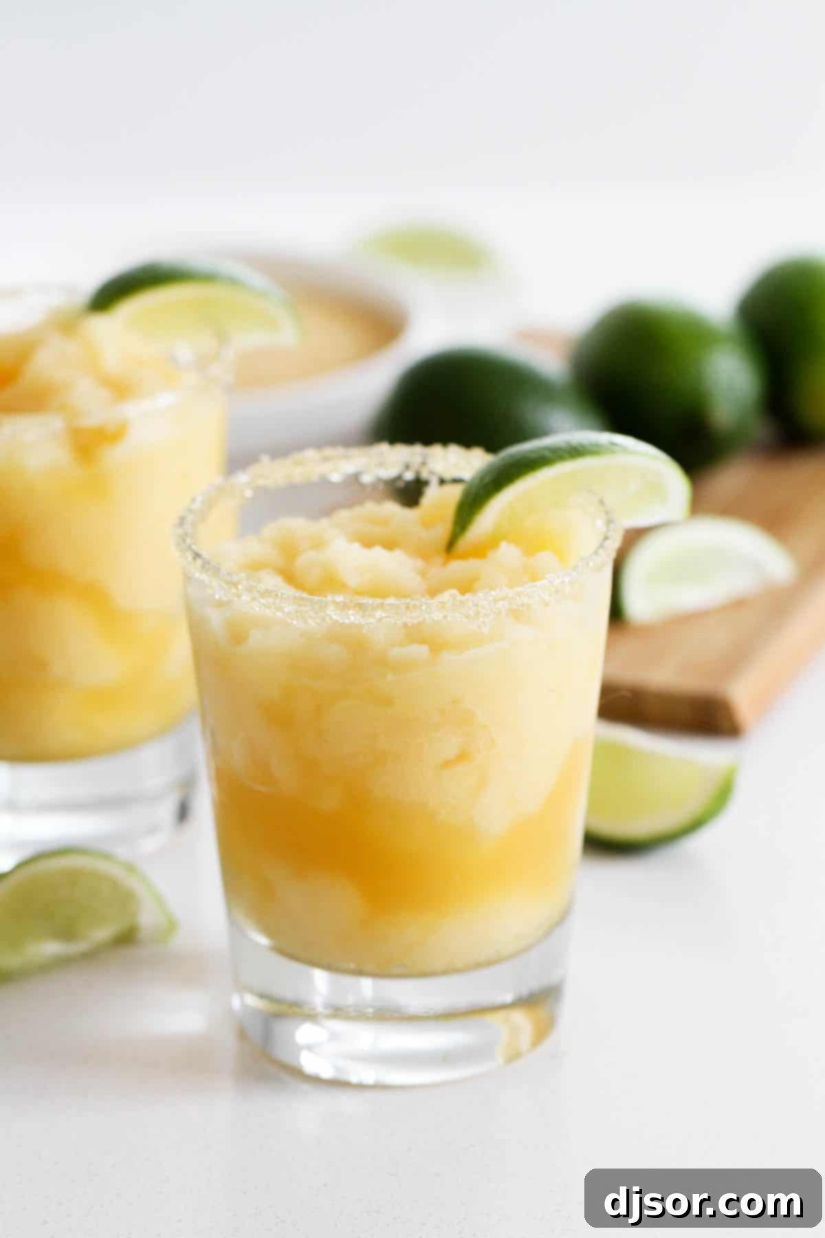 A little bit tart, a little bit sour, and a little bit sweet, these Virgin Frozen Margaritas come together in just minutes and are super family friendly! Virgin Frozen Margaritas with lime slices