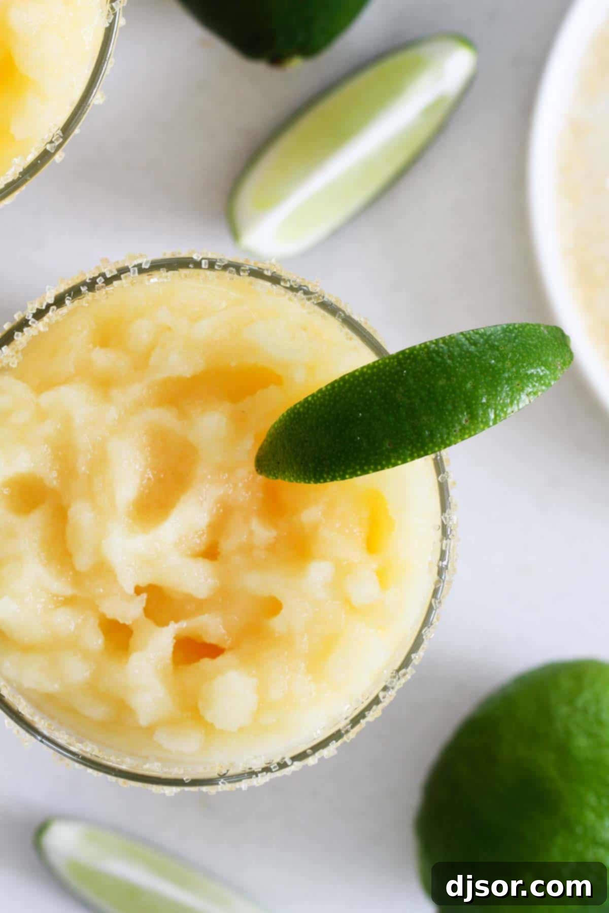 A little bit tart, a little bit sour, and a little bit sweet, these Virgin Frozen Margaritas come together in just minutes and are super family friendly! Frozen Margaritas with no alcohol topped with limes