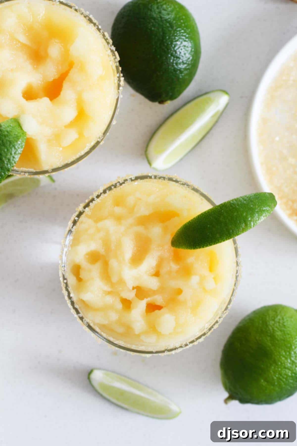 A little bit tart, a little bit sour, and a little bit sweet, these Virgin Frozen Margaritas come together in just minutes and are super family friendly! virgin margaritas - family friendly drinks topped with fresh limes