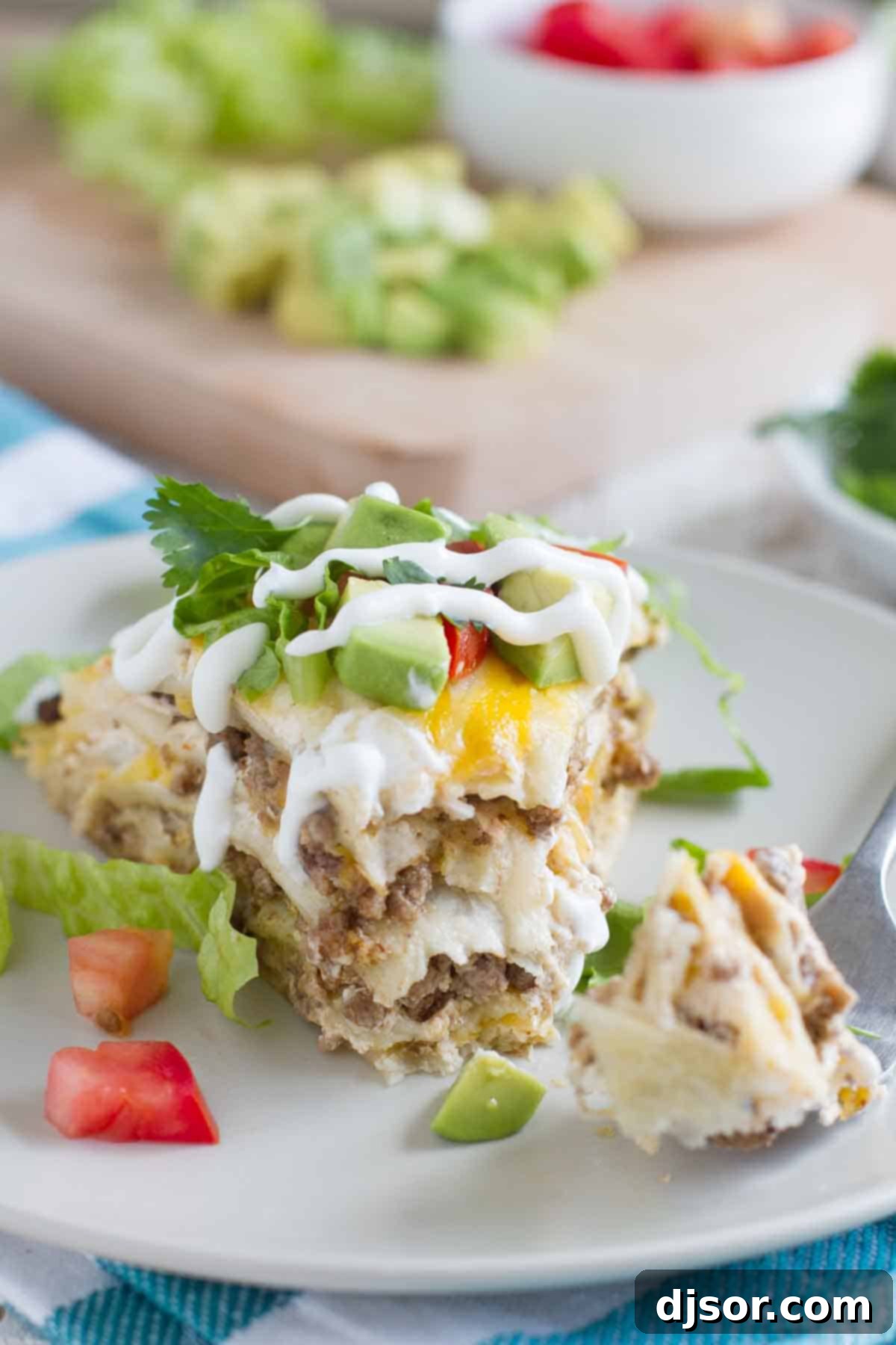 close-up of taco tortilla stack with a bite taken out, showing the creamy and meaty interior
