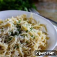 A delectable bowl of Mizithra Cheese Pasta, garnished with fresh parsley, ready to be enjoyed.