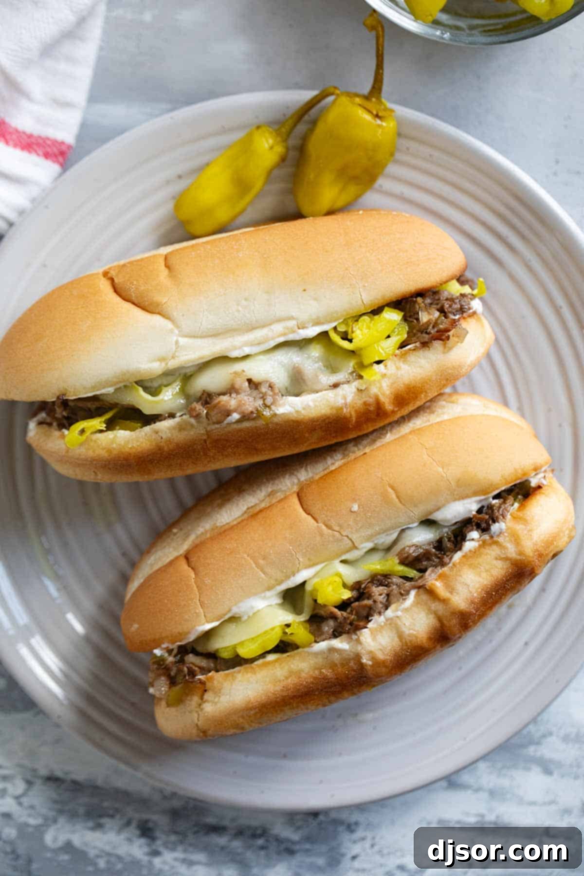 Chicago's Iconic Italian Beef 7 Two Italian Beef Sandwiches on a plate, garnished with pepperoncini peppers.