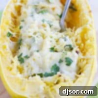 A healthier way to serve a favorite dip, this Spinach Artichoke Spaghetti Squash Recipe has squash combined with spinach, artichokes, and a creamy cheese sauce.