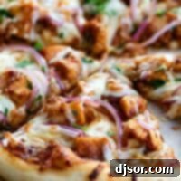bbq chicken pizza topped with bbq sauce, chicken, onions and cilantro