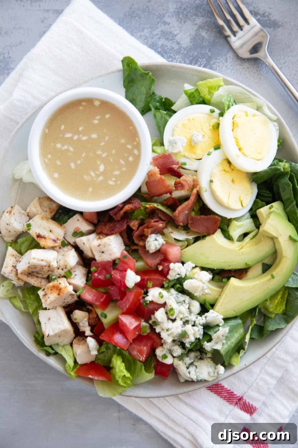 Cobb Salad serving on a plate with homemade dressing.
