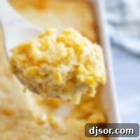 Wooden spoon full of corn casserole.