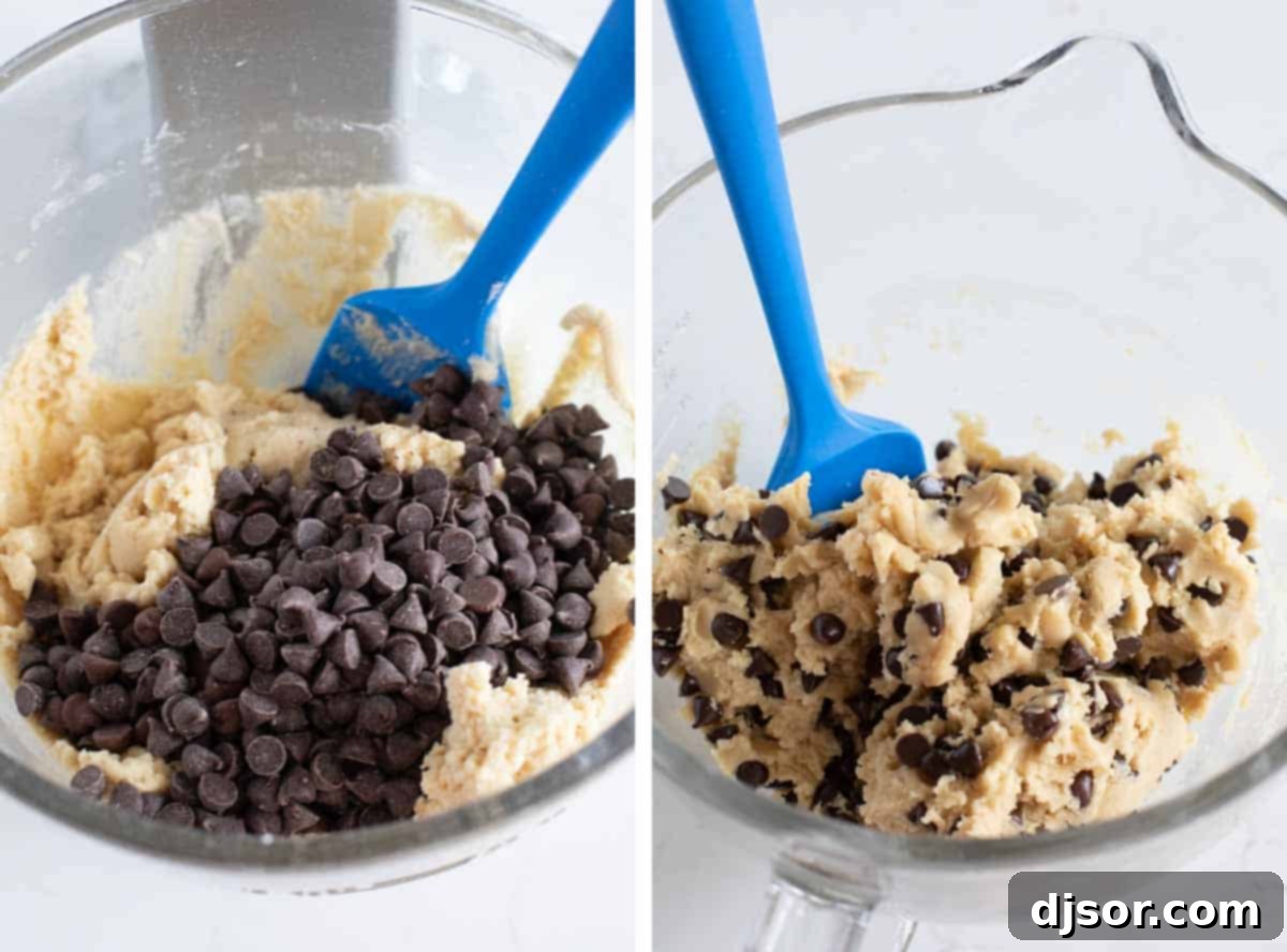 Folding chocolate chips into the cookie dough by hand. Chocolate chips being stirred into the prepared cookie dough.