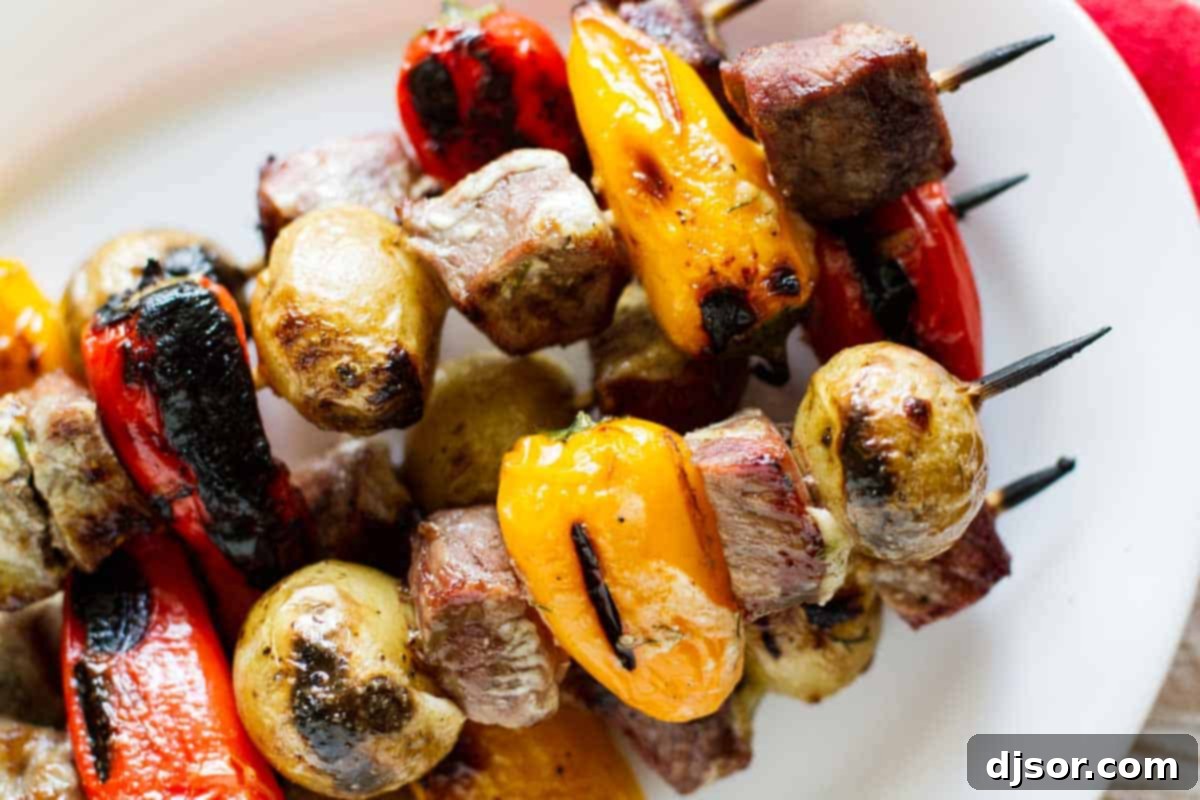 Charred Steak and Potato Kabobs, glistening with grill marks and ready to serve.