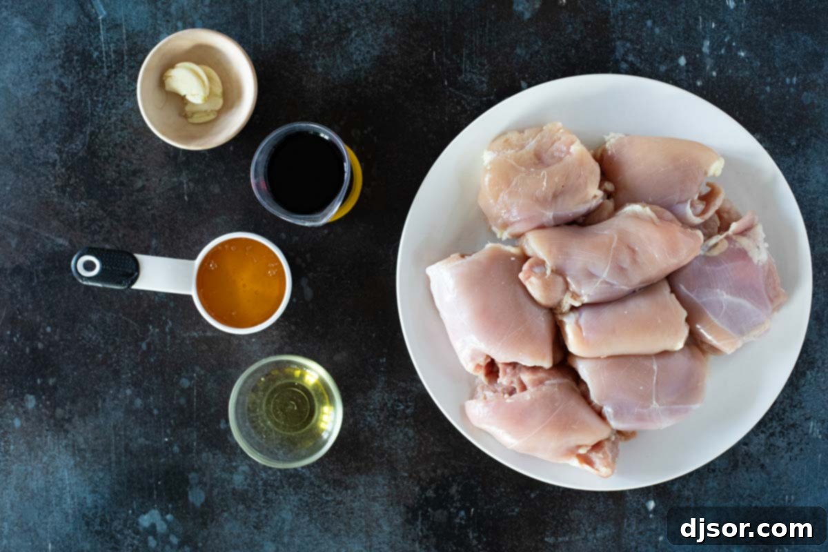 Sticky Honey Soy Glazed Chicken 3 A display of the simple ingredients needed to prepare Honey Soy Chicken, including soy sauce, honey, sesame oil, and garlic.
