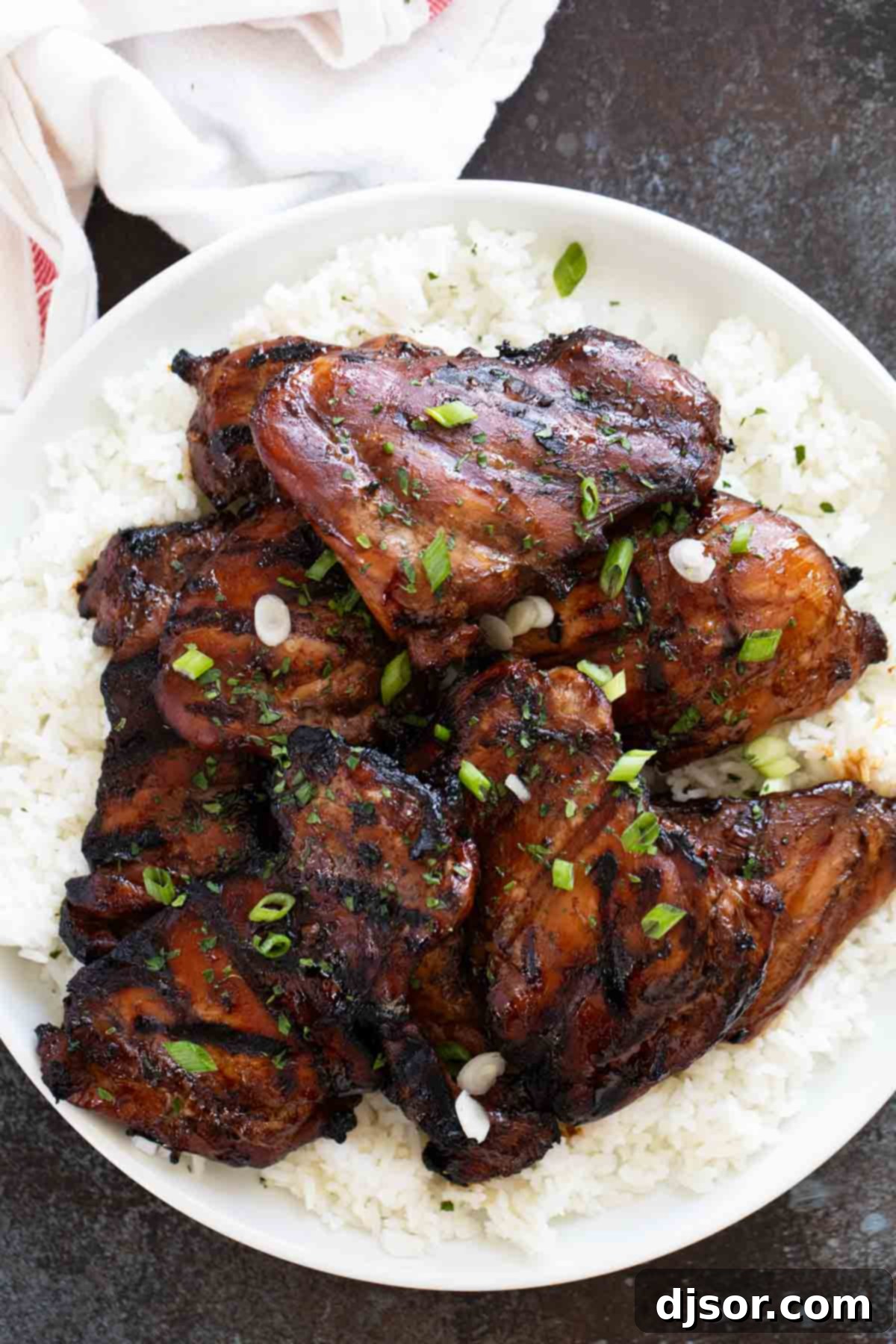 Sticky Honey Soy Glazed Chicken 6 Perfectly grilled honey soy chicken served over fluffy white rice, garnished for a complete meal.