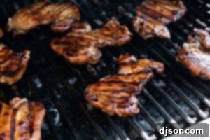 Sticky Honey Soy Glazed Chicken 9 Honey Soy Chicken cooking on a grill.