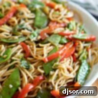 dish with lo mein noodles with cabbage, peas and peppers