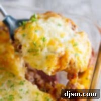 Fluffy Pizza Bake 2 Puffed Up Pizza Casserole being scooped out.