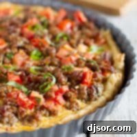 Savory Italian Tart - A perfectly golden brown tart, rich with Italian sausage, juicy tomatoes, eggs, and cheese, resting on a flaky puff pastry.