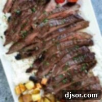 Korean Flank Steak over rice on a serving platter.
