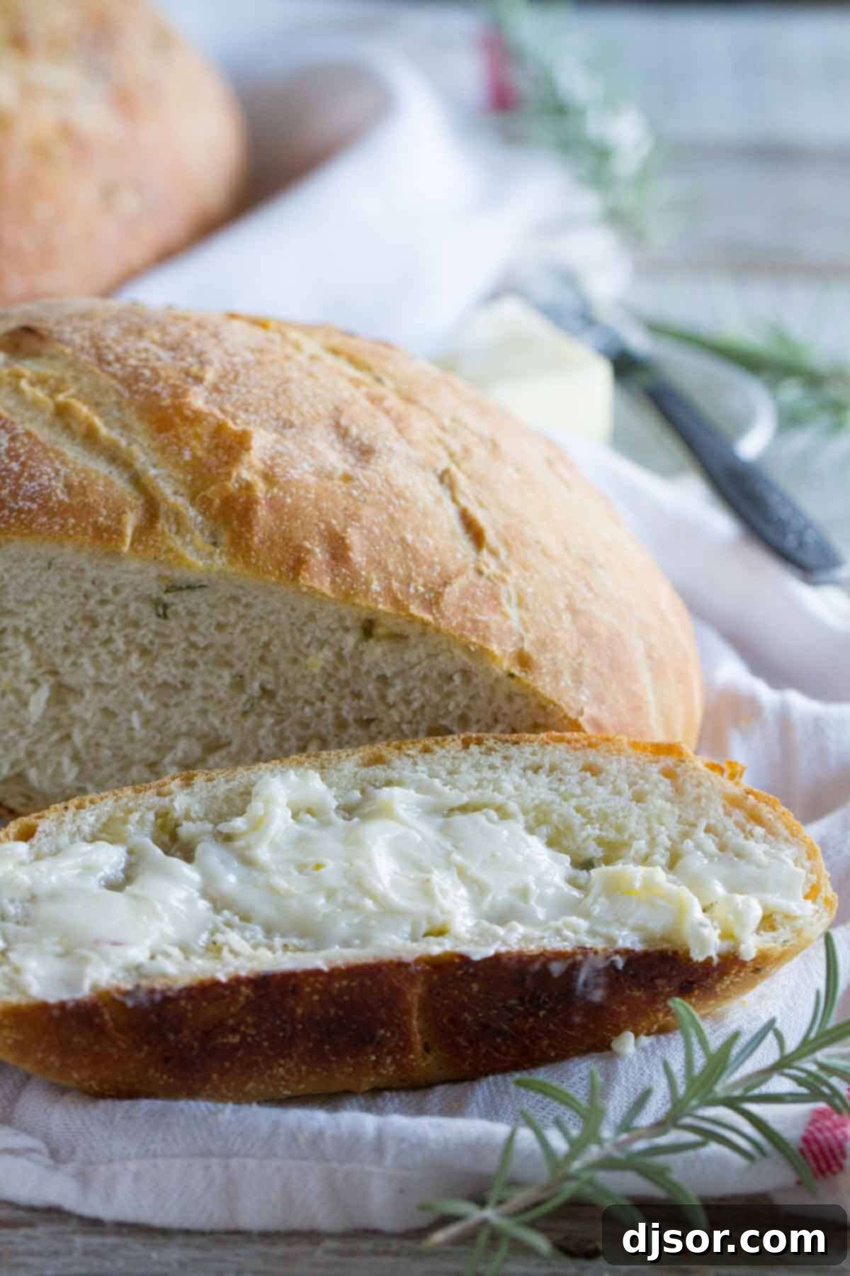 A perfectly sliced piece of potato bread, revealing its soft crumb, buttered and ready to be enjoyed.