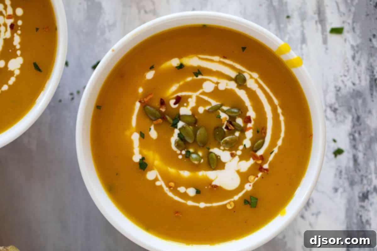 Multiple bowls of creamy Curried Butternut Squash Soup, beautifully garnished with fresh parsley, crunchy pepitas, and a swirl of cream, ready to be enjoyed.
