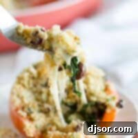 A beautifully prepared Cheesy Italian Stuffed Tomato, ready to be enjoyed.