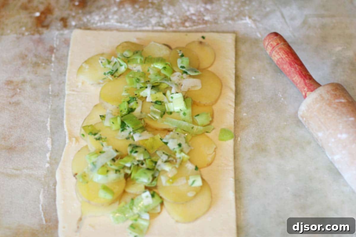 Creamy potato, leek, and cheese filling ready to be encased in puff pastry for a savory pie.
