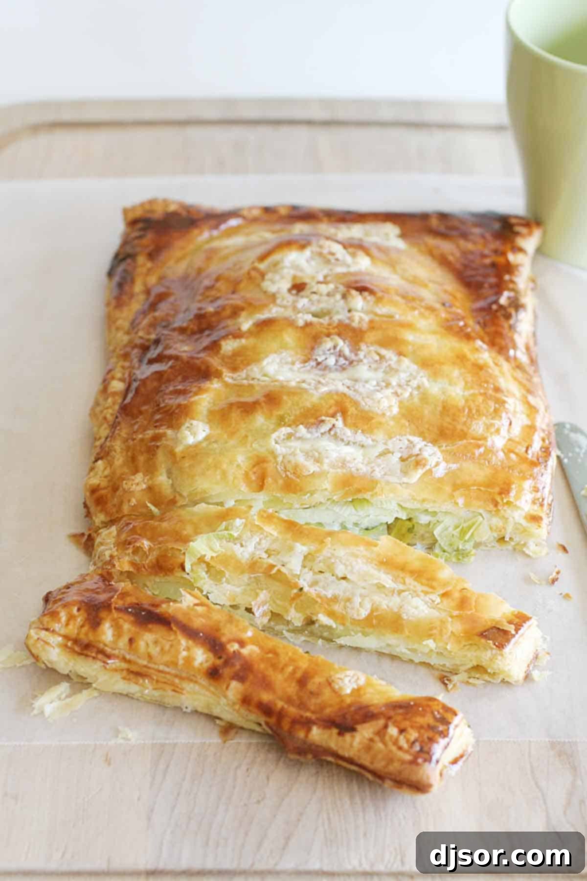 Puff Pastry Potato Pie sliced into individual servings, showcasing the layers of potato, leek, and cheese.