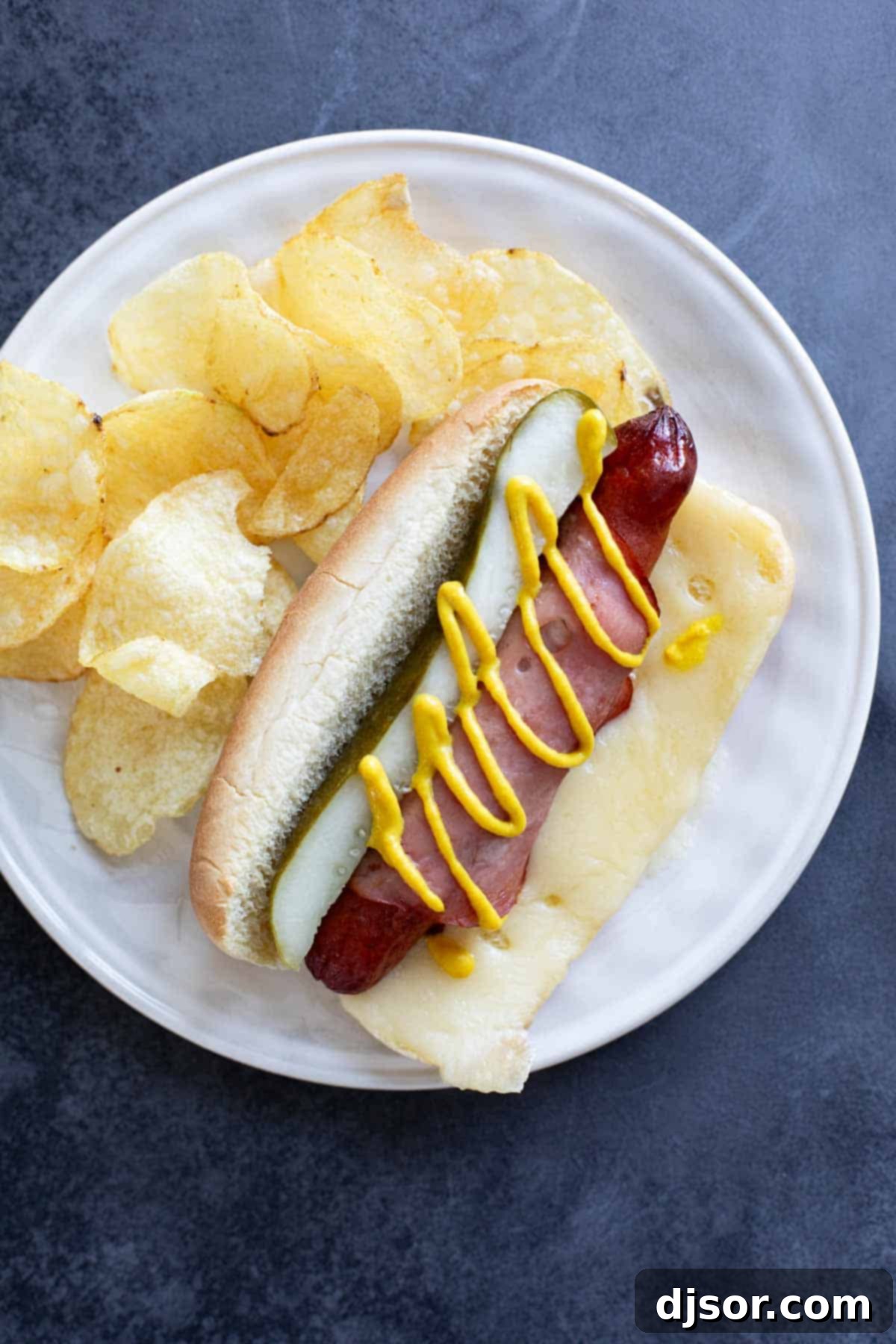 Havana Hot Dogs 6 Cuban hot dog on a plate with potato chips.