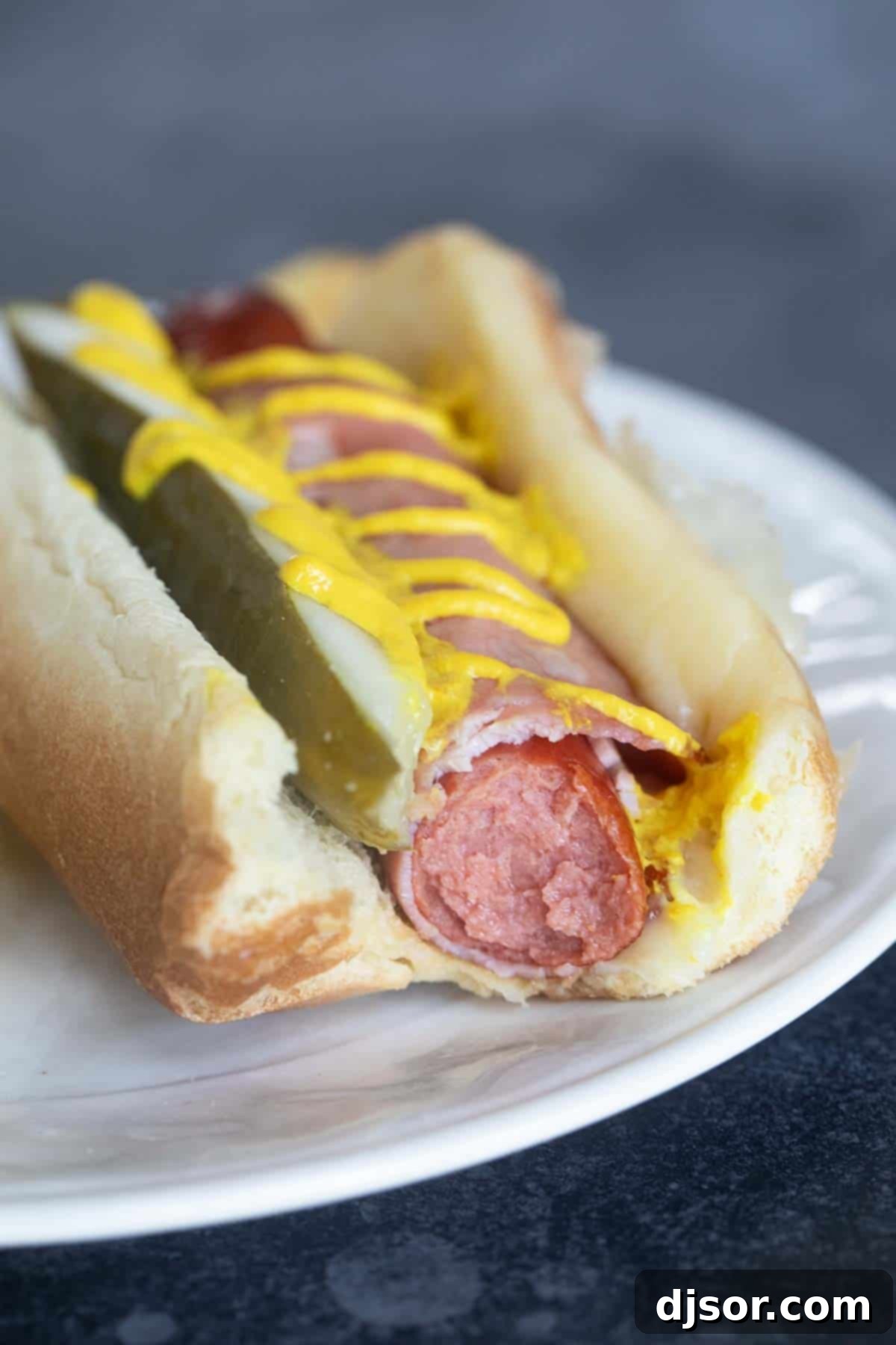 Havana Hot Dogs 7 Cuban Hot Dog with a bite taken from it.