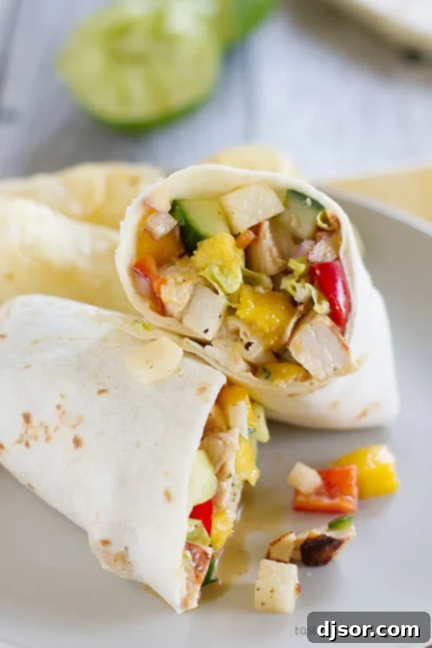 Colorful Mango Chicken Salad featuring chicken, mango, and a variety of fresh vegetables. Great as a wrap, sandwich, or bowl meal.