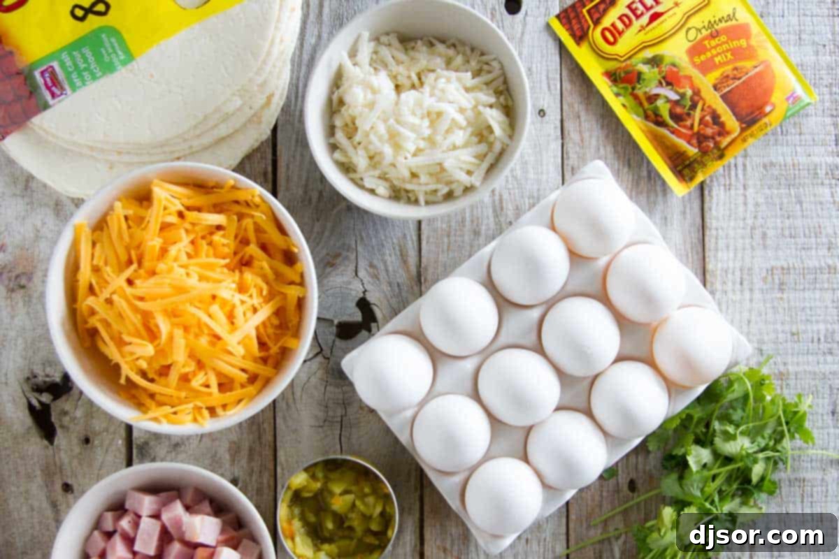 A selection of fresh ingredients laid out on a cutting board, including eggs, hash browns, ham, cheese, and Old El Paso seasoning and chiles.