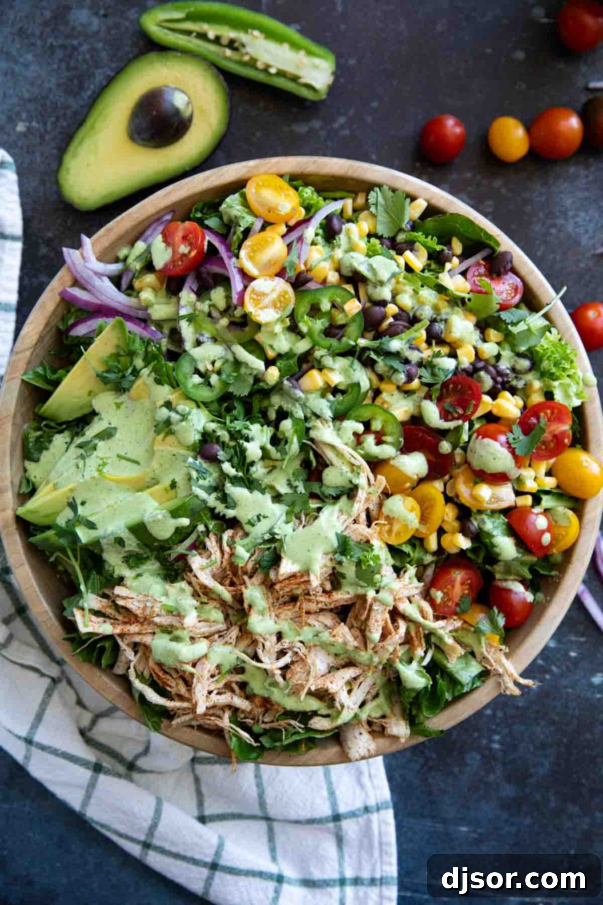 Southwest chicken salad with tomatoes, corn, black beans, onions, and shredded chicken.