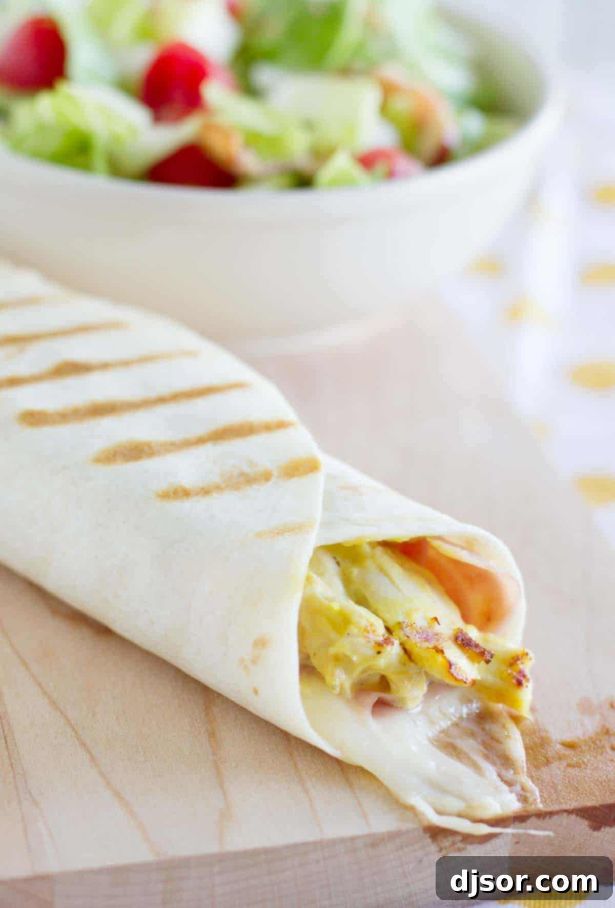 Cordon Bleu Grilled Chicken Wraps 4 Close-up of a Grilled Chicken Cordon Bleu Wrap, showing the texture of shredded chicken and melted cheese.