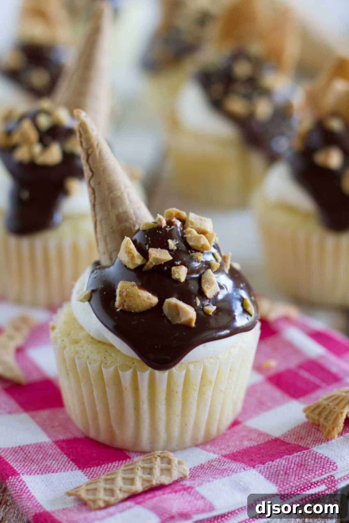 Drumstick Cupcakes topped with chocolate, peanuts, and ice cream cone pieces, arranged invitingly on a cooling rack.