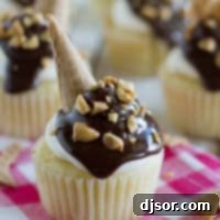 Drumstick Cupcakes topped with chocolate, peanuts, and ice cream cone pieces.