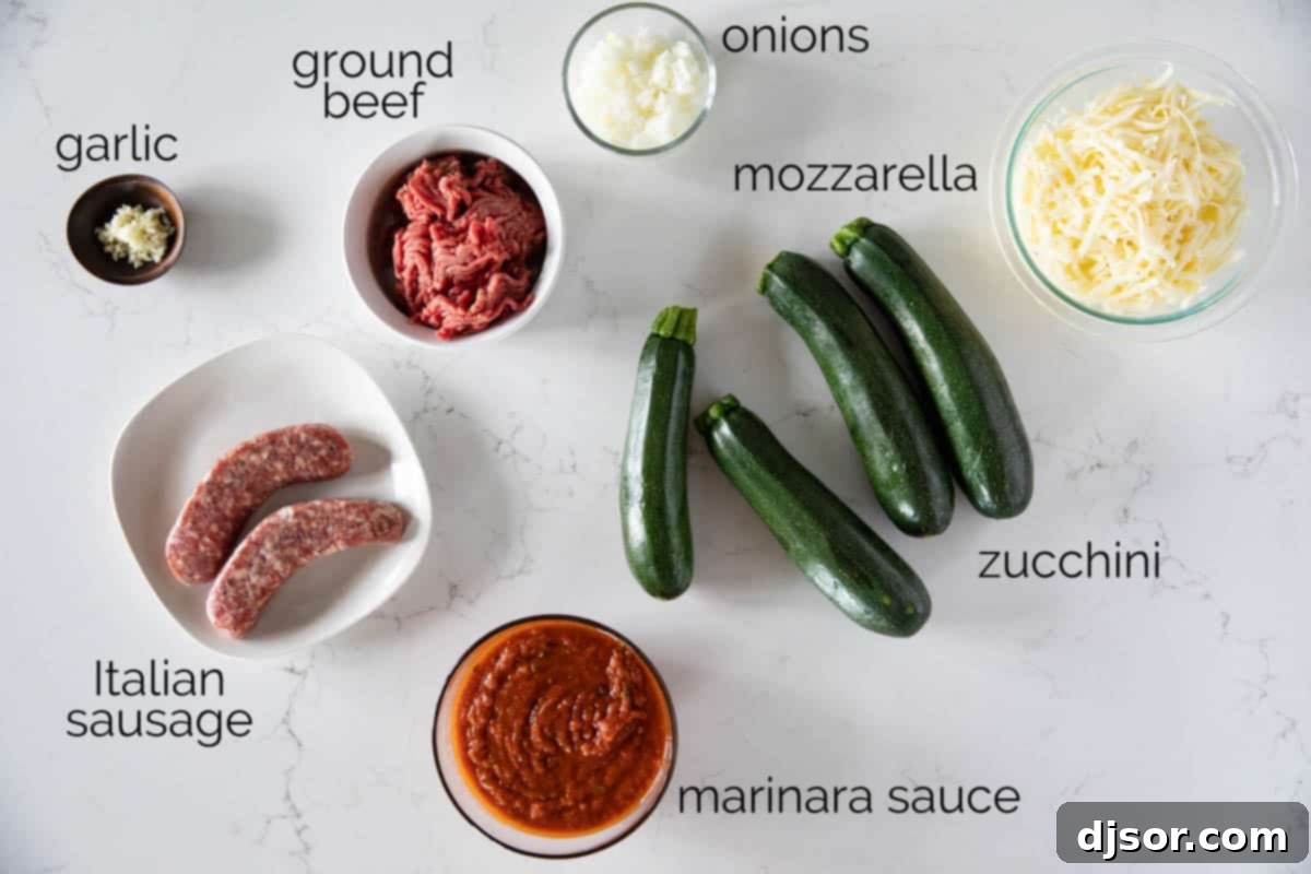 A selection of fresh ingredients laid out on a kitchen counter, ready for making stuffed zucchini boats. Includes zucchini, ground beef, Italian sausage, onion, garlic, olive oil, marinara sauce, and mozzarella cheese.
