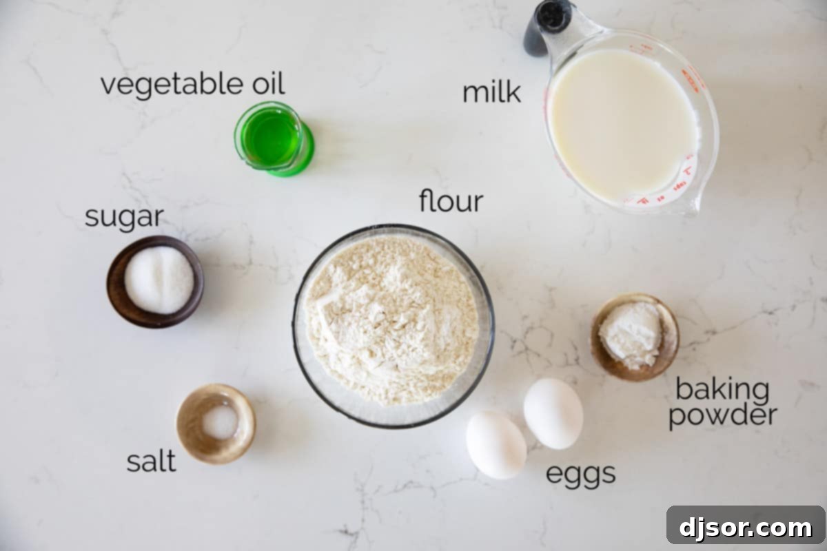 Assortment of fresh ingredients laid out on a kitchen counter, prepared for making waffles from scratch.
