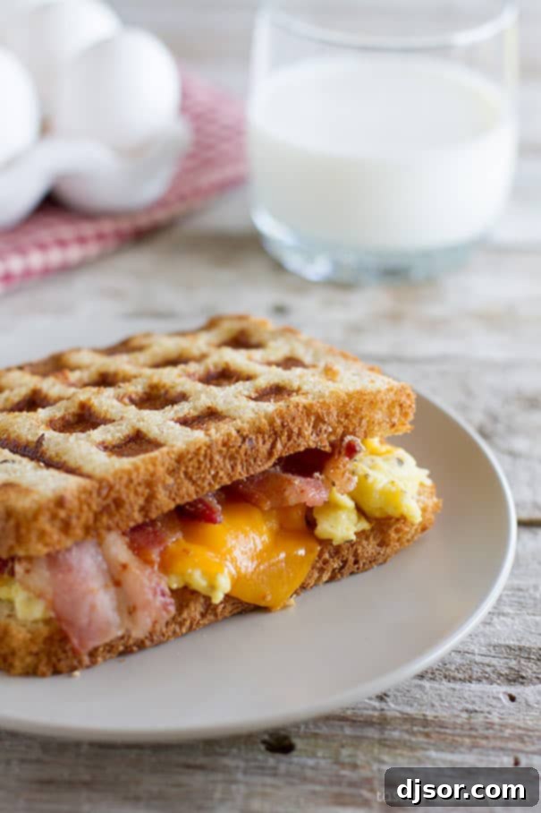 Delicious Waffled Breakfast Grilled Cheese Sandwich with Scrambled Eggs and Bacon