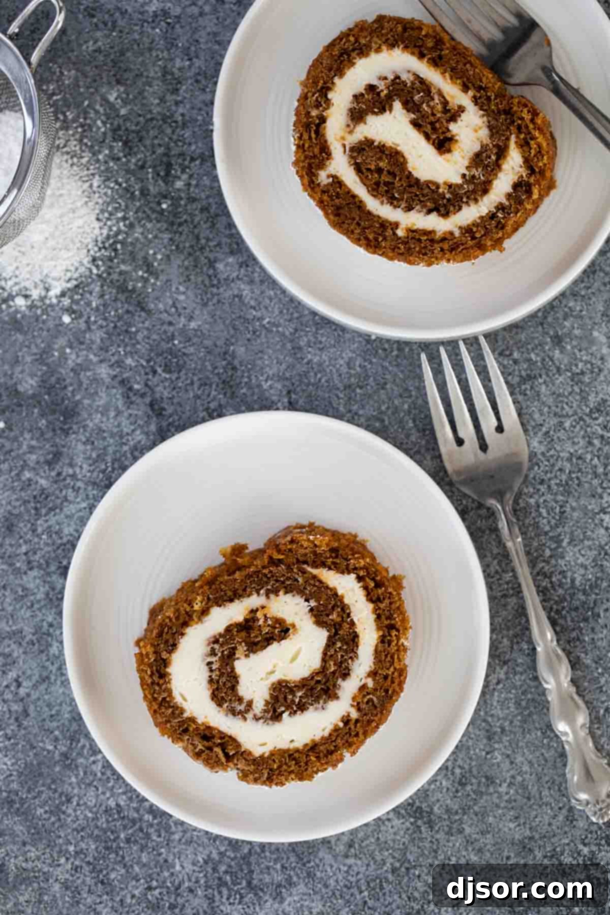 Overhead view of several slices of pumpkin roll arranged on a serving platter.