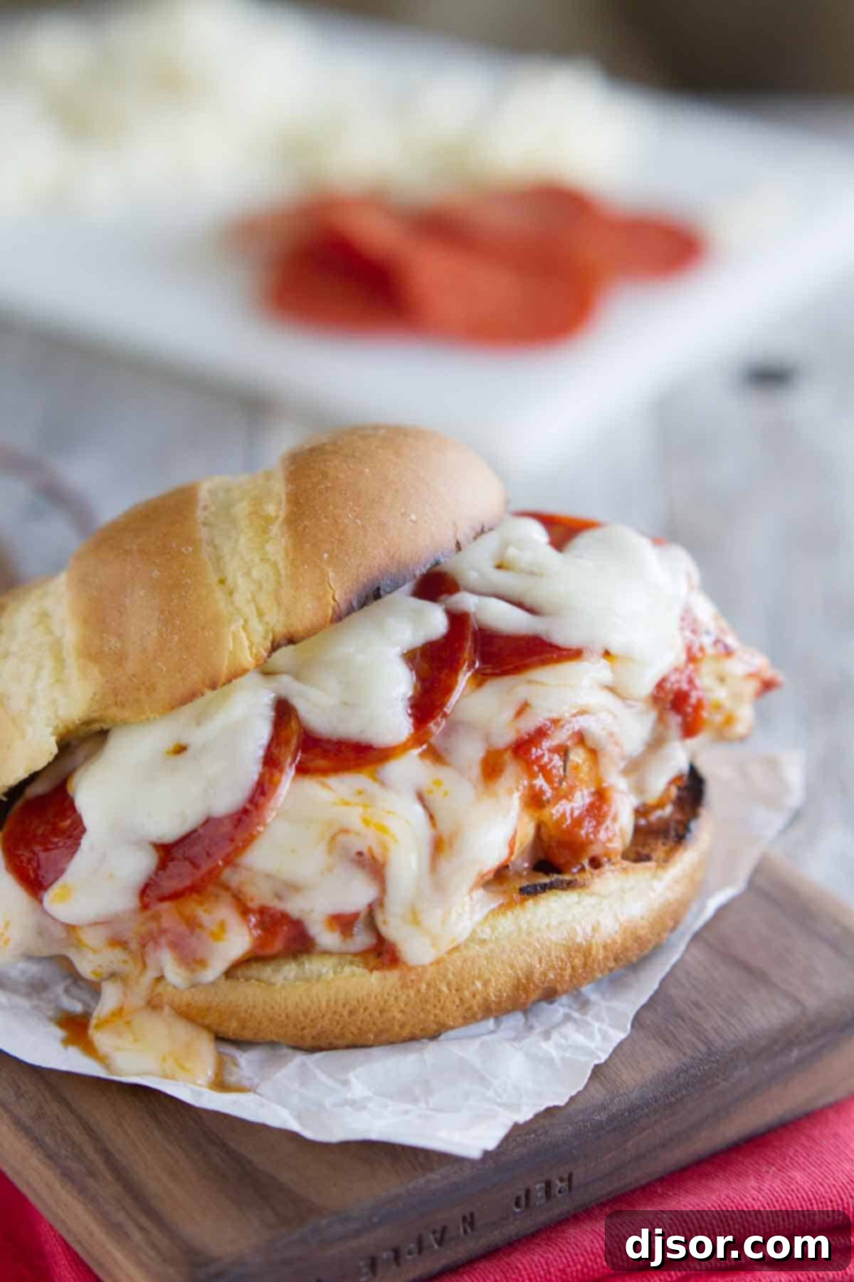 Delicious Pizza Topped Grilled Chicken Sandwich on a rustic cutting board, ready to be served