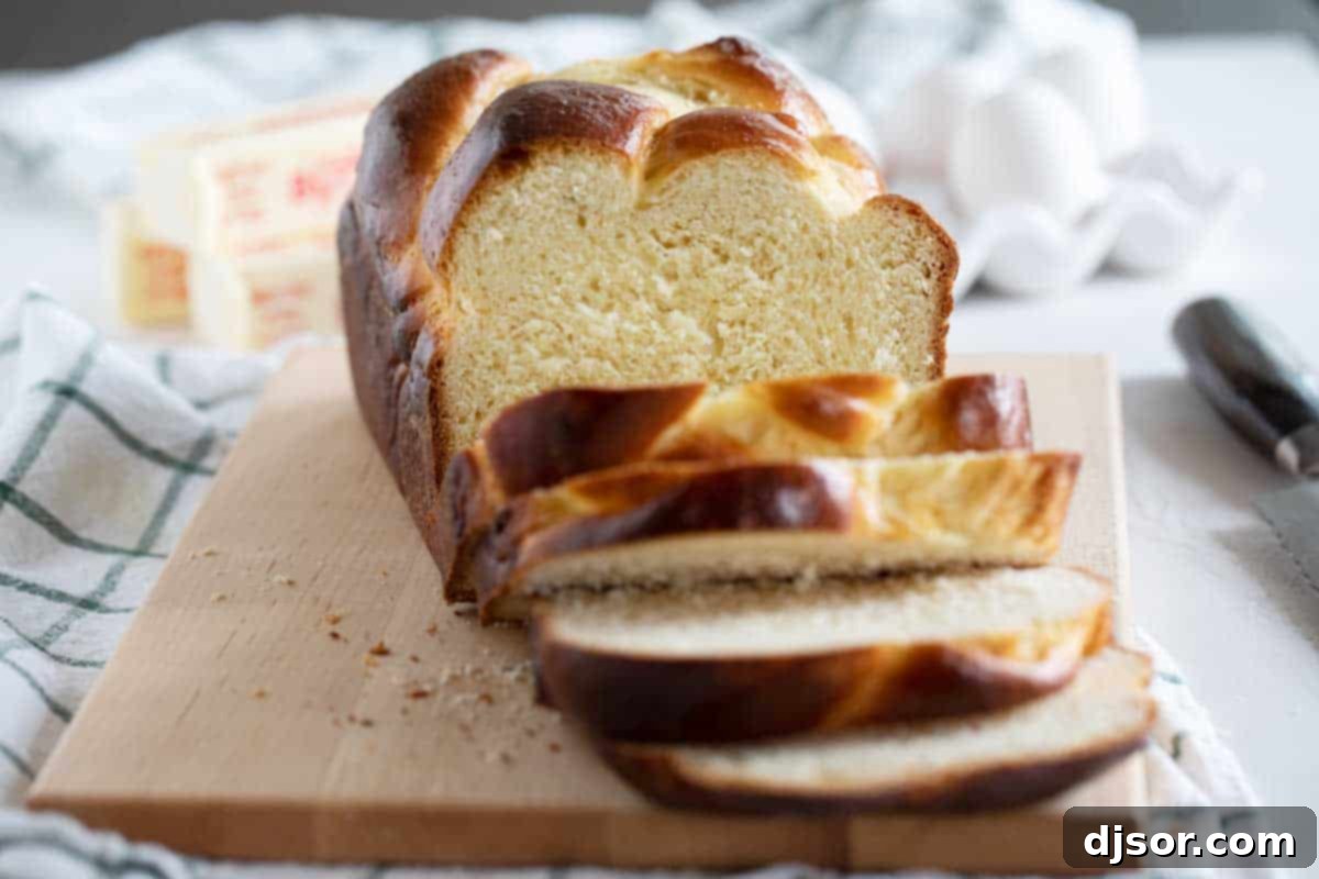 A golden brown loaf of sliced brioche bread on a wooden cutting board, showcasing its soft and airy texture. It's garnished with a dusting of powdered sugar, inviting a delightful bite.