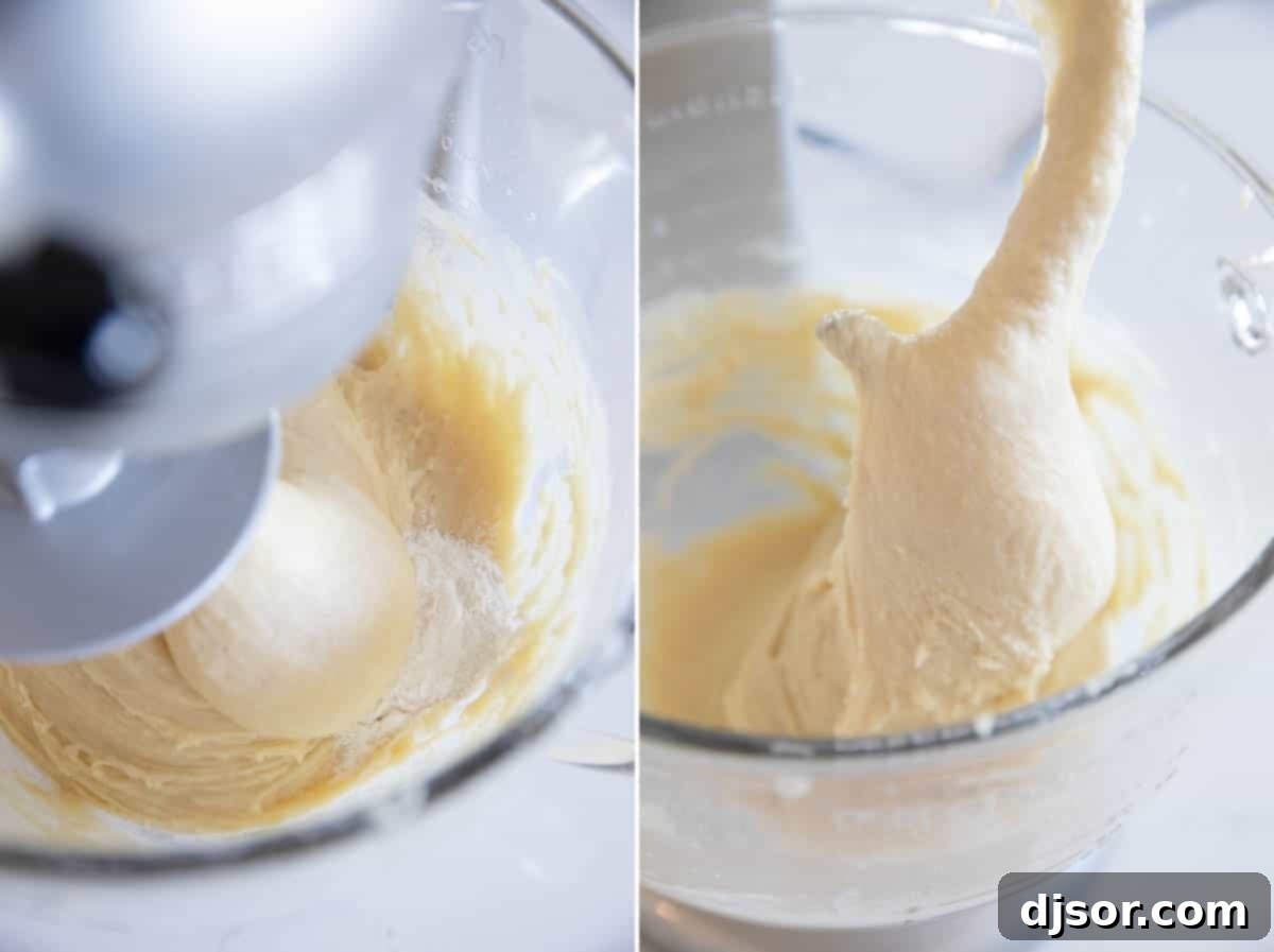 Soft brioche bread dough being vigorously kneaded in a stand mixer with a dough hook, showing its sticky but developing texture as it pulls away from the bowl.