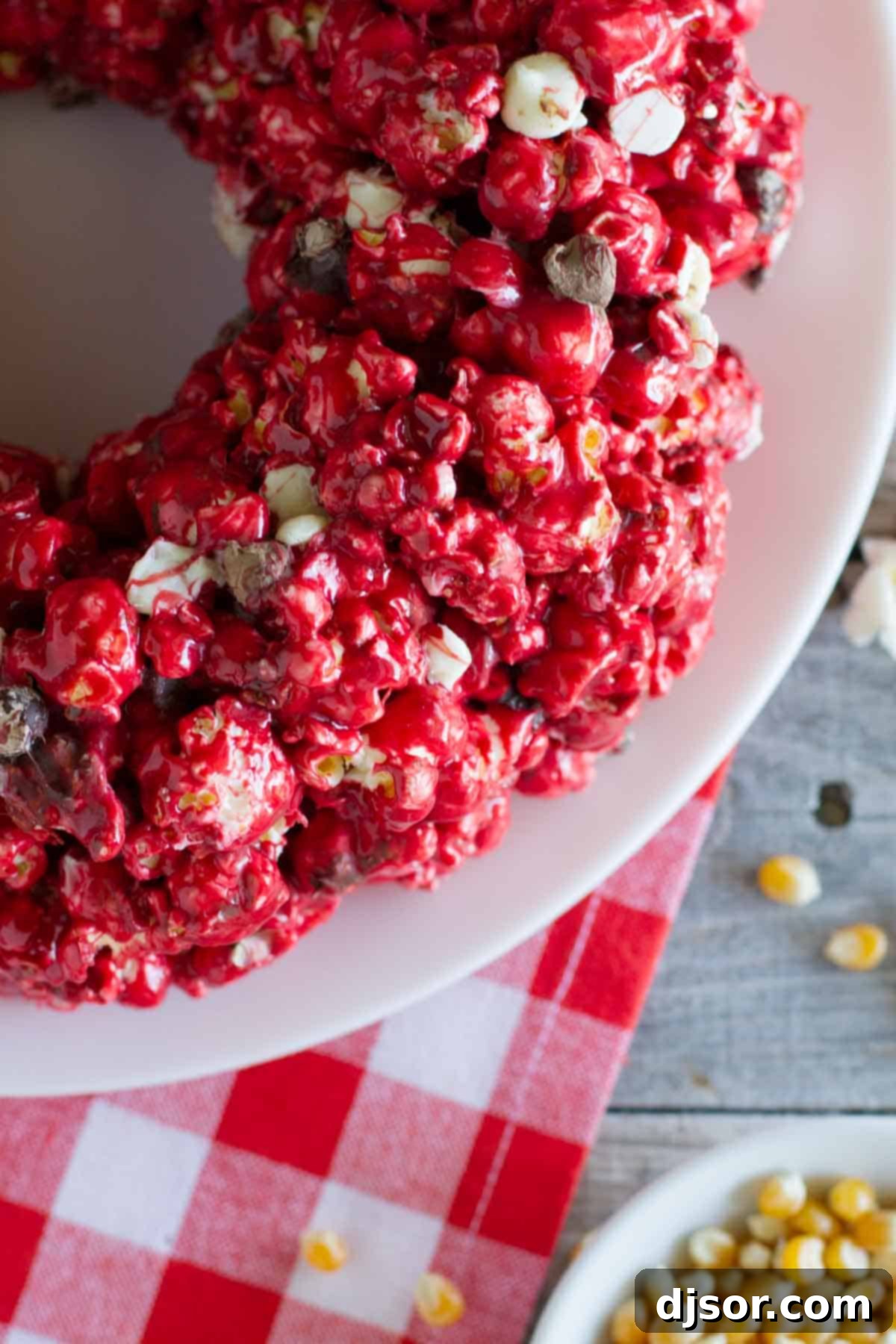 Decadent Red Velvet Popcorn Cake 3 Close-up of Red velvet popcorn cake with chocolate chips on a decorative plate.