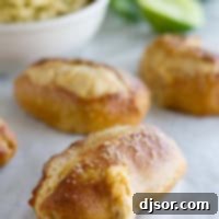 Spicy Taco Pretzel Sticks 9 Jalapeno Stuffed Taco Soft Pretzel Sticks on parchment with guacamole for dipping in the background.