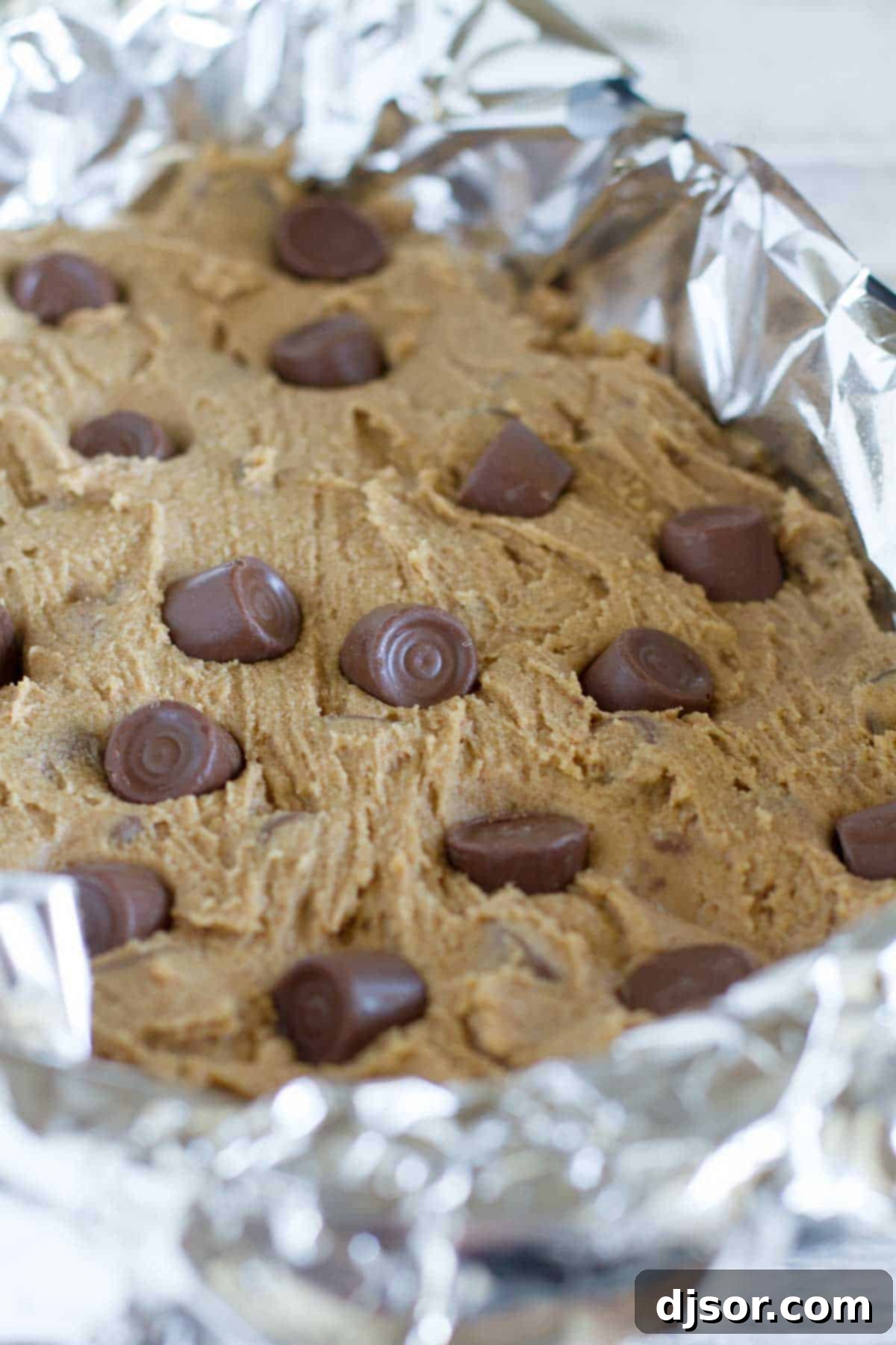 Close-up of Spice Cake Caramel Blondies, showcasing the melted chocolate caramel candies embedded within the golden-brown batter.