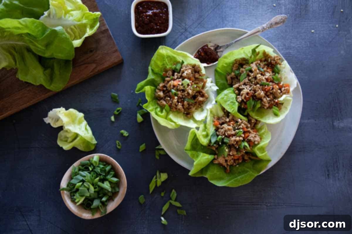 chicken lettuce wraps on a plate with ingredients close by