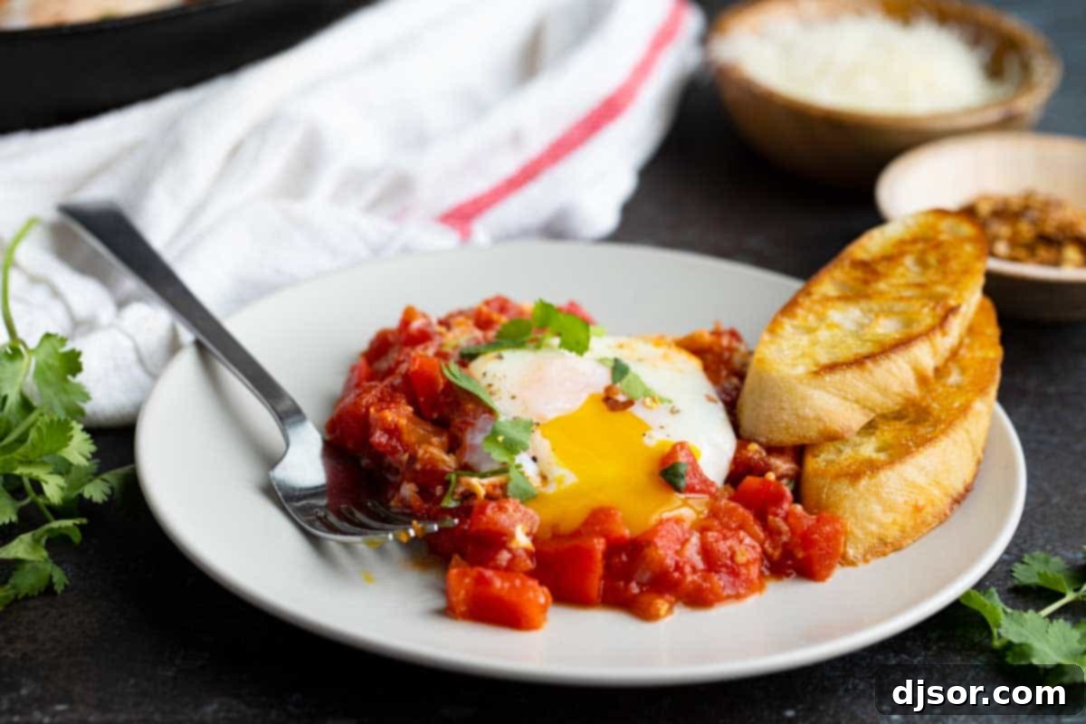 plate with shakshuka and crusty bread