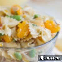 Asian Sesame Noodle Salad 4 Oriental Pasta Salad with pasta, mandarin oranges, and edamame in a large glass bowl.