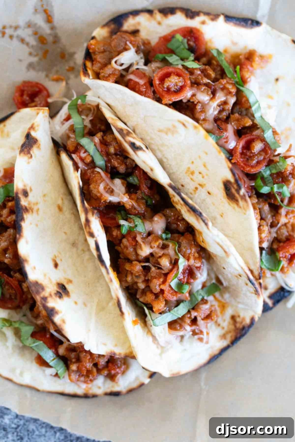 Pizza Tacos with sausage, pepperoni, cheese, and basil.