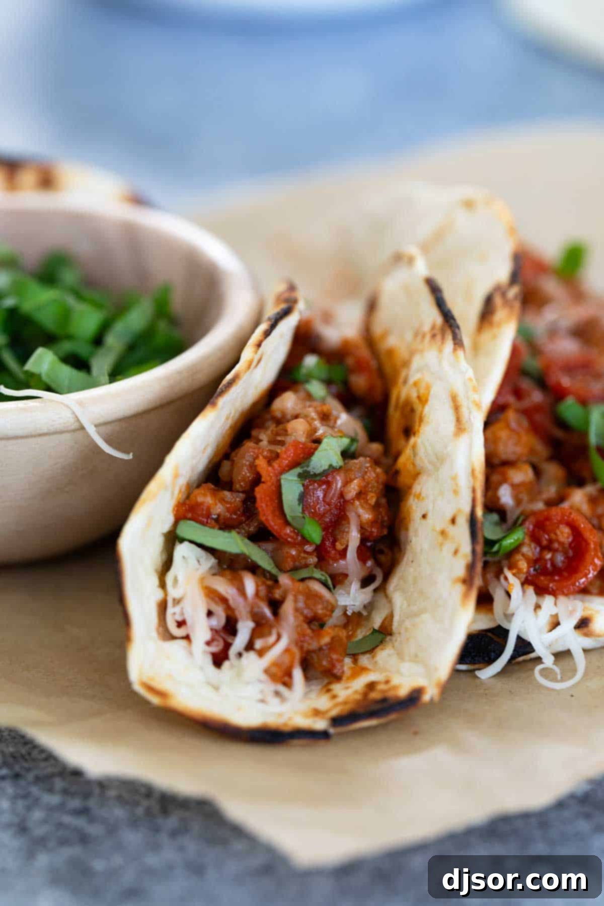 Pizza Tacos with a bowl of fresh basil.